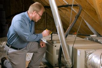 Broomfield furnace repair specialist works on a Carrier furnace installed in an attic