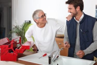 Plumber in Broomfield Colorado talks with customer during sink repair